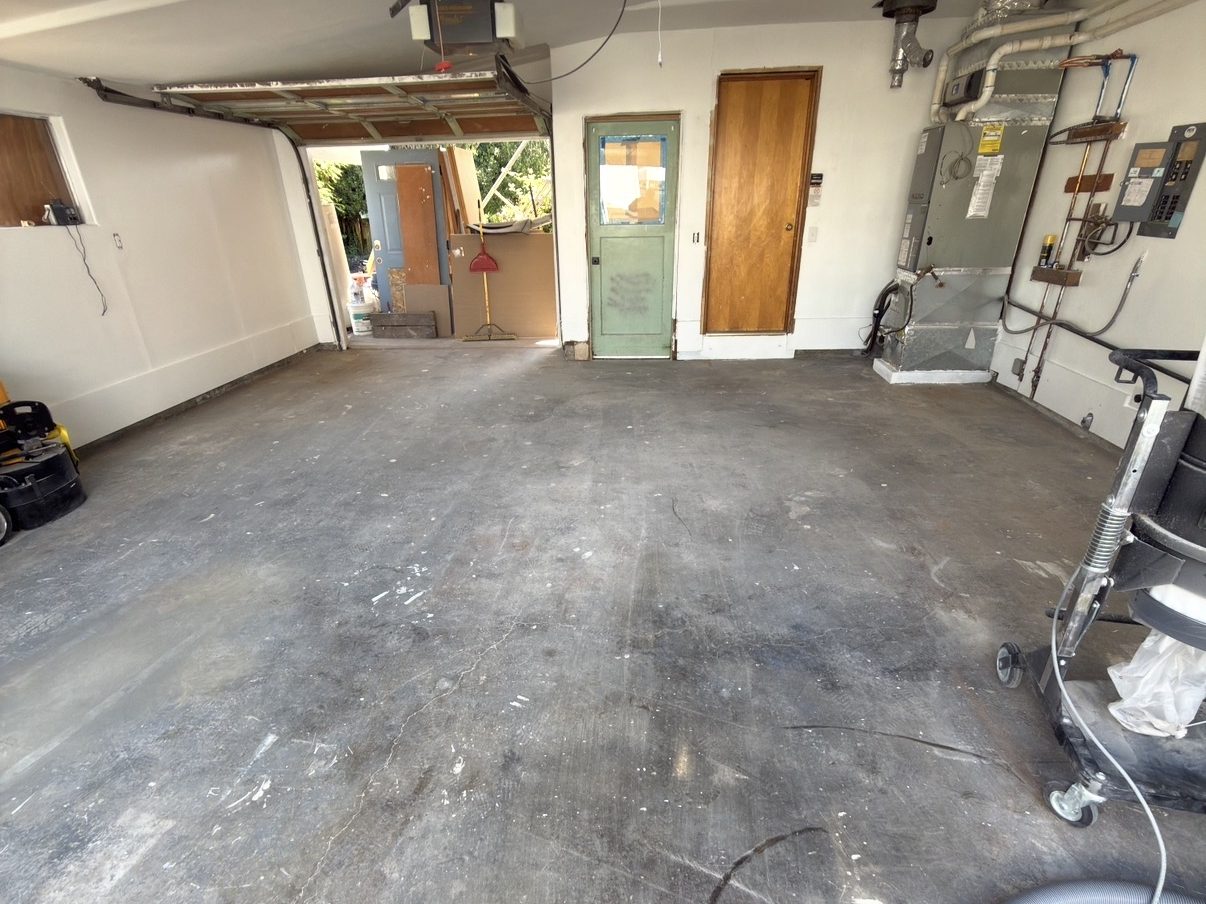 Garage before, bare stained concrete