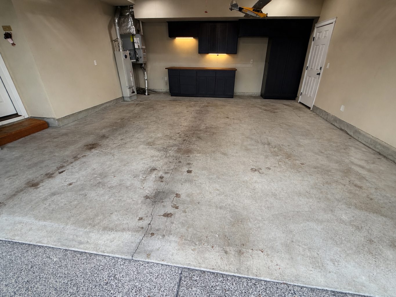 Residential garage before, bare stained concrete